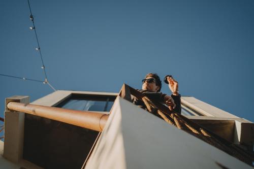 a man standing on top of a building at The Pangea Valle de Guadalupe in Valle de Guadalupe