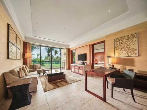 a living room with a couch and a table at Wanda Realm Resort Sanya Haitang Bay in Sanya