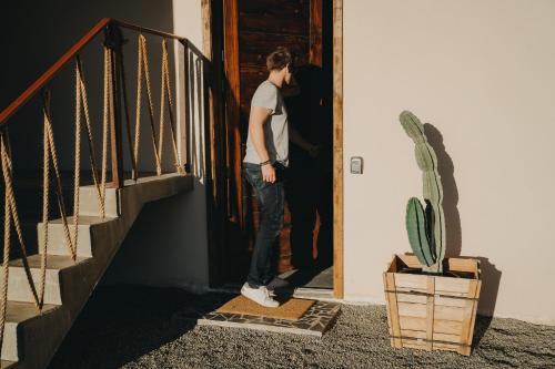 a man standing at the door of a house at The Pangea Valle de Guadalupe in Valle de Guadalupe