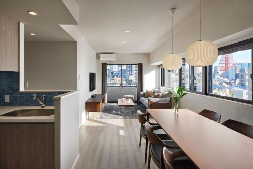 a kitchen and living room with a table and a couch at Oakwood Hotel & Apartments Azabu Tokyo in Tokyo