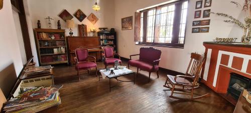 a living room with purple chairs and a fireplace at San Felipe el Real in Chihuahua