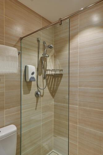 a shower stall with a glass door in a bathroom at Cititel Mid Valley in Kuala Lumpur