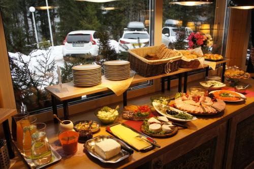 a buffet of food on a table with plates and dishes at Gronik in Szczyrk