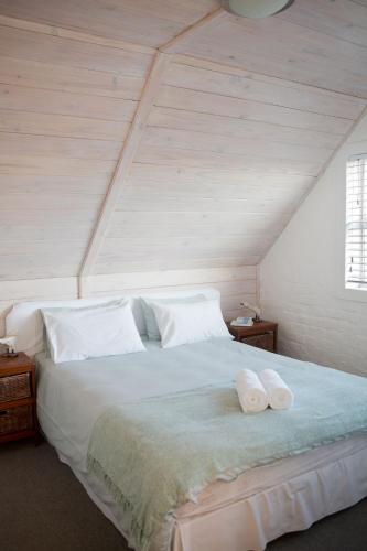 a bedroom with a bed with two towels on it at Villa Del Mar in Clareport