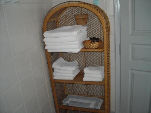 a bamboo towel rack with towels in a bathroom at Archipelagos Sunset Apartments in Posidhonía