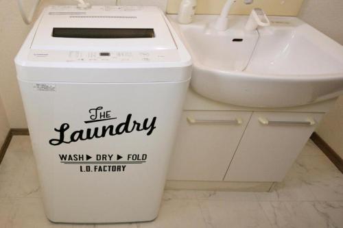 a trash can and a sink in a bathroom at goom Hotel Nakasu in Fukuoka
