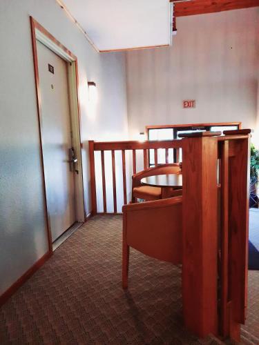 a room with a balcony with a table and a door at North Ironwood Acres - Black River Lodge in Ironwood