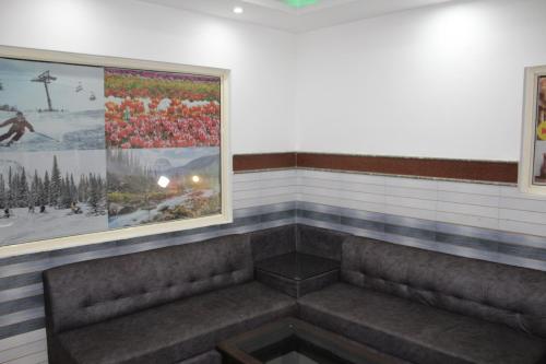 a waiting room with two benches and a painting at Trimrooms Katra Railway Station in Katra