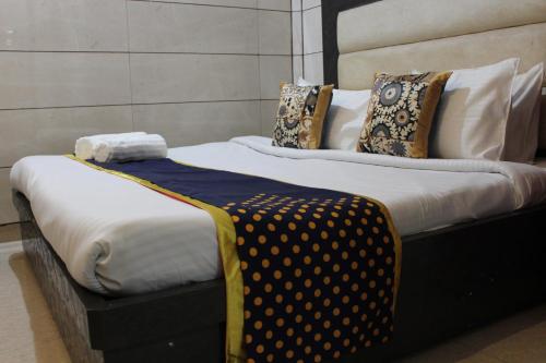 a couple of beds with pillows on them at Trimrooms Katra Railway Station in Katra