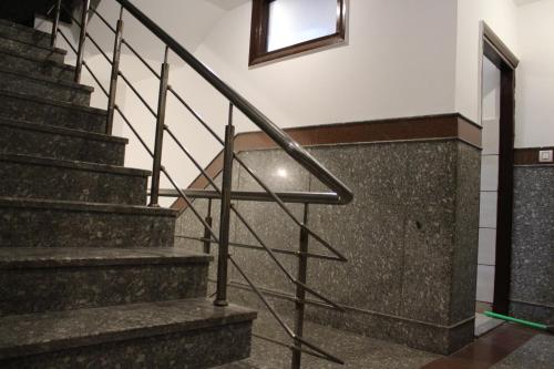 a set of stairs in a building with a window at Trimrooms Katra Railway Station in Katra