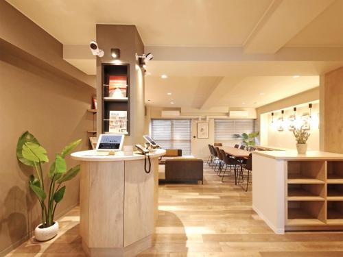 an office with a counter with a laptop on it at Lestel Maru in Sapporo