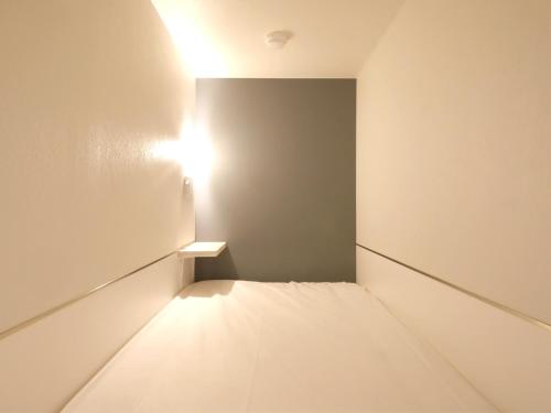 an empty room with a light on the wall at Lestel Maru in Sapporo