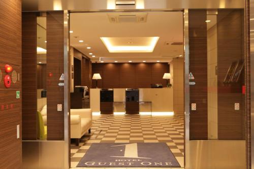 a lobby of a hotel with a guest one sign on the door at HOTEL Guest1 Ueno Ekimae in Tokyo