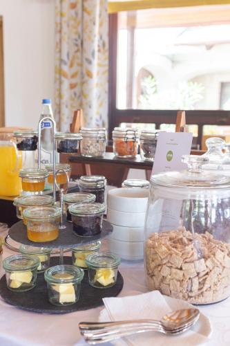 a buffet of food on a table with jars of food at Fiastyúk Udvarház in Csór