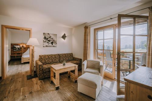 a living room with a couch and a table at Alpe Dornach in Oberstdorf