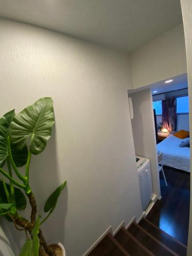 a room with a potted plant and a bedroom at Takemura Building 2nd floor in Tokyo