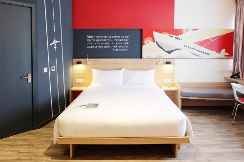 a bedroom with a large bed in a room at Ibis Saigon Airport in Ho Chi Minh City