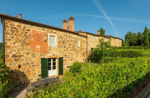 an old brick building with a tower on top of it at Piccolo Borgo Gagnoni in Sinalunga