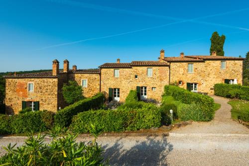 an old stone house with a garden in front of it at Piccolo Borgo Gagnoni in Sinalunga