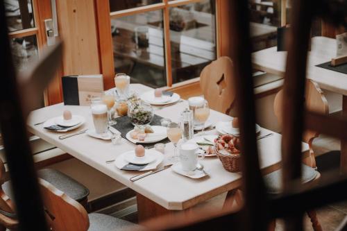 a table with plates of food on top at Alpe Dornach in Oberstdorf