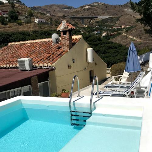 a villa with a swimming pool and a house at Casa Hector in Granada