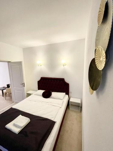 a bedroom with a large bed with a black blanket at COCHET BOUTIQUE in Târgu Jiu