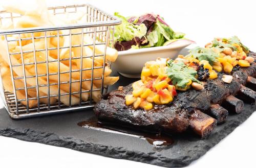 a plate of food with meat and vegetables and a salad at The Samaya Seminyak Bali in Seminyak