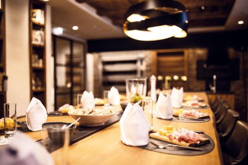 a long table with plates of food on it at Hotel Gotthard in Lech am Arlberg
