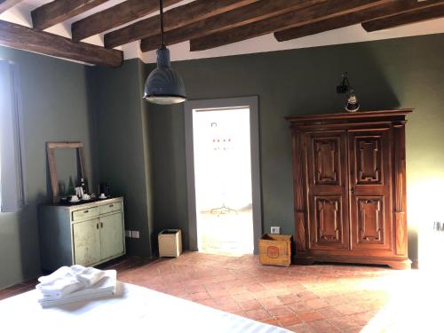 a bedroom with a bed and a dresser and a window at La Locanda di Grazzano Visconti in Grazzano Visconti