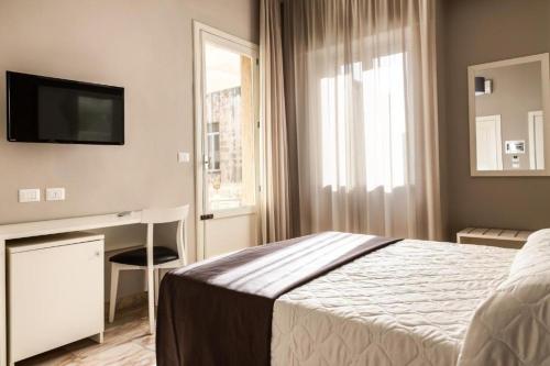 Katil atau katil-katil dalam bilik di Faro Bianco Gallipoli - Suites & Apartments