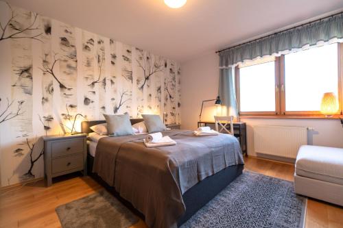 a bedroom with a bed and a large window at Apartament Na Wzgórzu z widokiem na góry - Dream Apart in Wisła