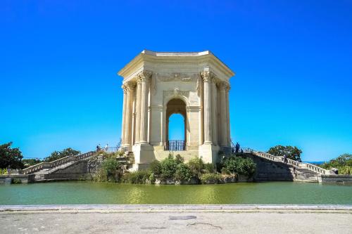 a large building in the middle of a pool of water at Radisson Blu Hotel, Montpellier in Montpellier