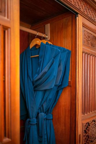 a blue curtain is hanging on a door at Hoi An Riverside Villas & Apartments in Hoi An