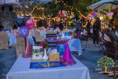 a table with pink hats on top of it at Temple Tree Resort & Spa, Pokhara in Pokhara