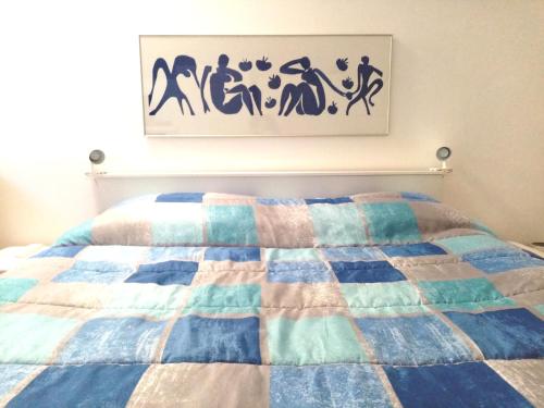 a bedroom with a bed with a quilt on it at B&B accogliente a due passi dal metrò di Milano - Casa Adriana in Cologno Monzese