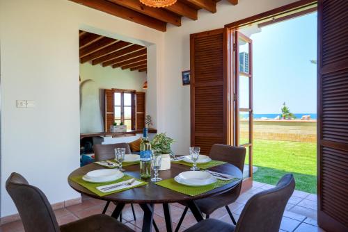 a dining room with a wooden table and chairs at The Olympians Villas in Polis Chrysochous