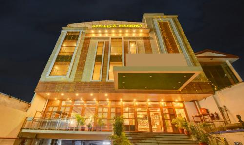 a building with lights on the front of it at Treebo Trend G K Residency Near Dehradun Railway Station in Dehradun