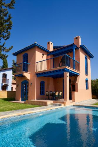 a house with a swimming pool in front of it at The Olympians Villas in Polis Chrysochous
