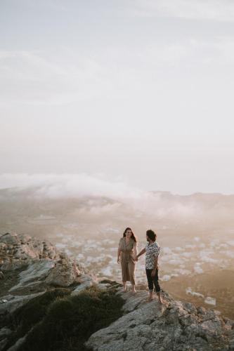 two people standing on top of a mountain at Santorini Sky, The Lodge in Pirgos