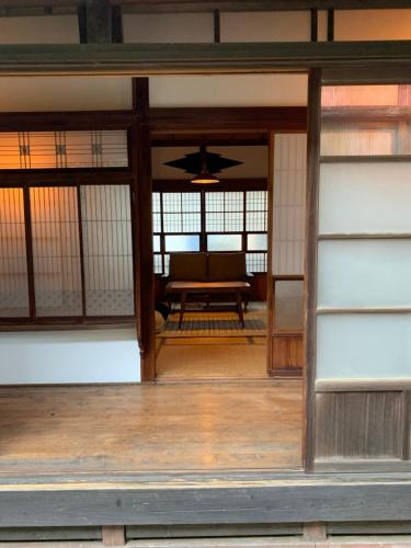an open door to a room with a table at uminca ウミンカ in Numazu