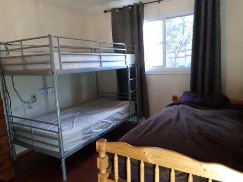 a bedroom with two bunk beds and a bed at OC House in Santa Ana