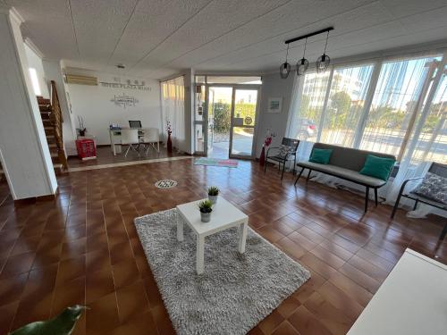 a living room with a couch and a table at Hotel Plaza Miami - Sólo Adultos in Miami Platja