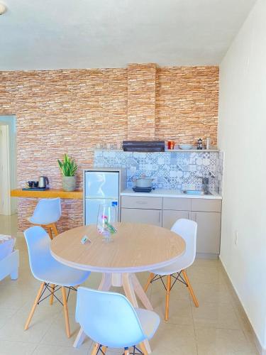 a kitchen with a table and chairs in a room at Nautica Hotel Apartments in Stavromenos