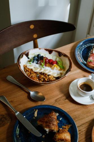 uma mesa com pratos de comida e uma xícara de café em One Shot Fortuny em Madrid