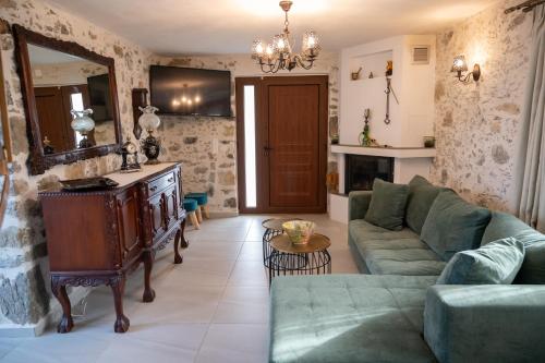 a living room with a couch and a mirror at Yiayia's Place in Vathiakón
