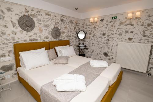 a bedroom with two beds with white towels on them at Yiayia's Place in Vathiakón