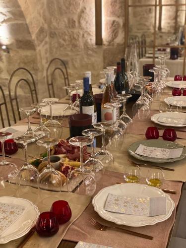 a long table with wine glasses and wine bottles at Inotropes Boutique Suites - Adults Only in Archanes