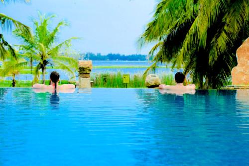 two people in a swimming pool in the water at Tara Watergate in Tissamaharama