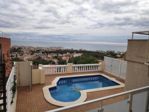 a balcony with a swimming pool on top of a building at BEACH HOUSE. CASA CON PISCINA PRIVADA in Calafell