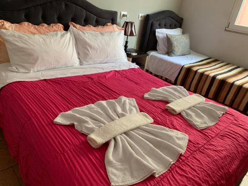 a bed with two towels on top of it at Guest House De Rada in Tirana
